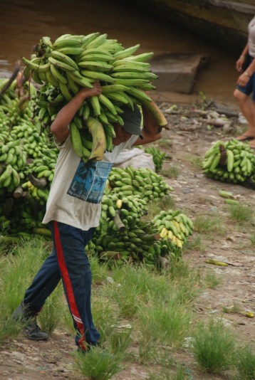 Man carrying plantains at the Amazon River port in Leticia, Colombia