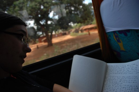 Bryanna Plog writing in her journal on a bus in northern Tanzania.