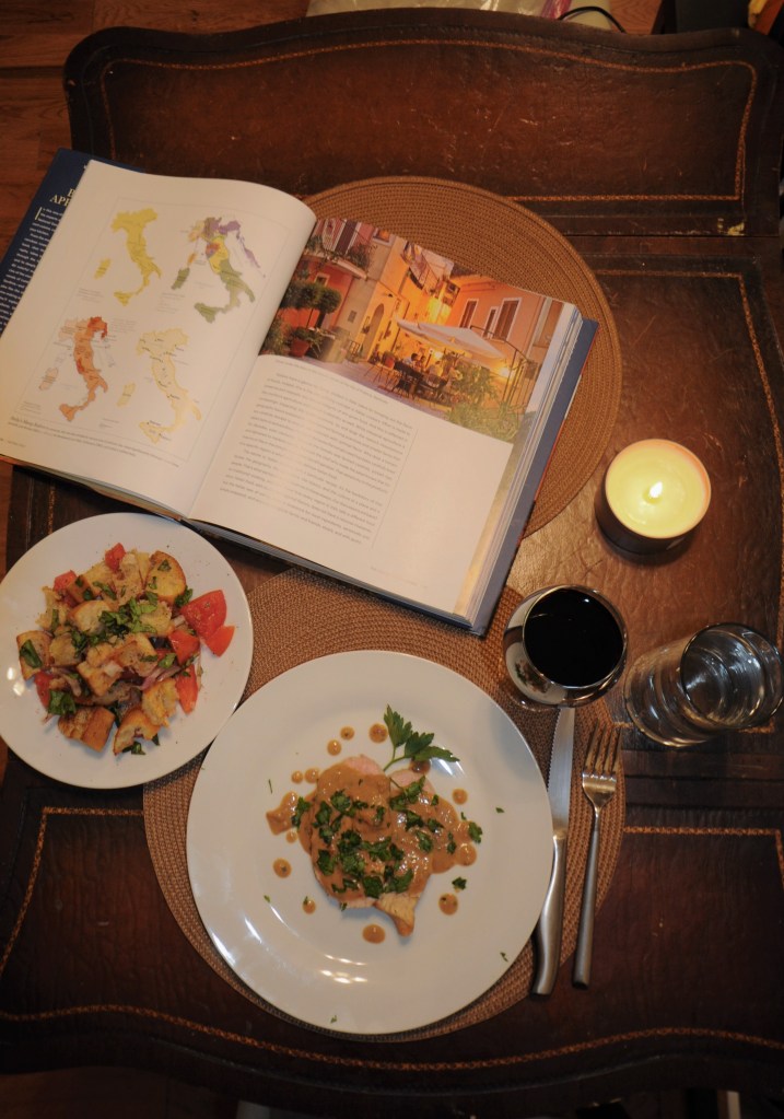 Dinner of pork, panzanella, wine, and the book.